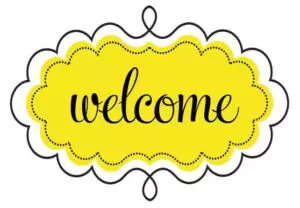 Decorative welcome sign featuring yellow scalloped oval with black cursive text and ornate border