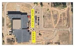 Aerial view of school building with yellow text overlays marking 'BUS ONLY' and 'DROP' zones for student transportation areas.